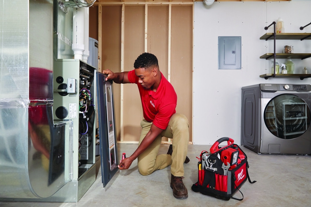 Technician repairing a furnace